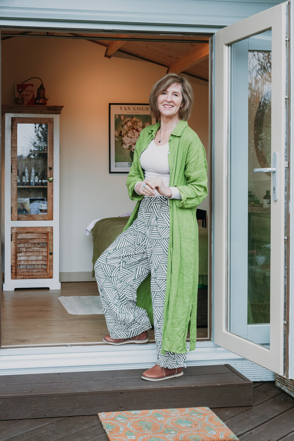 Nicki smiling in a calm doorway portrait