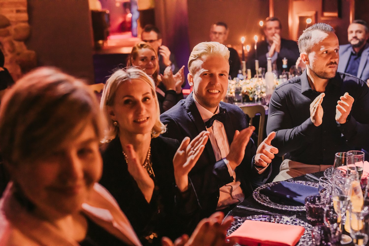 Guests applauding during an elegant dinner