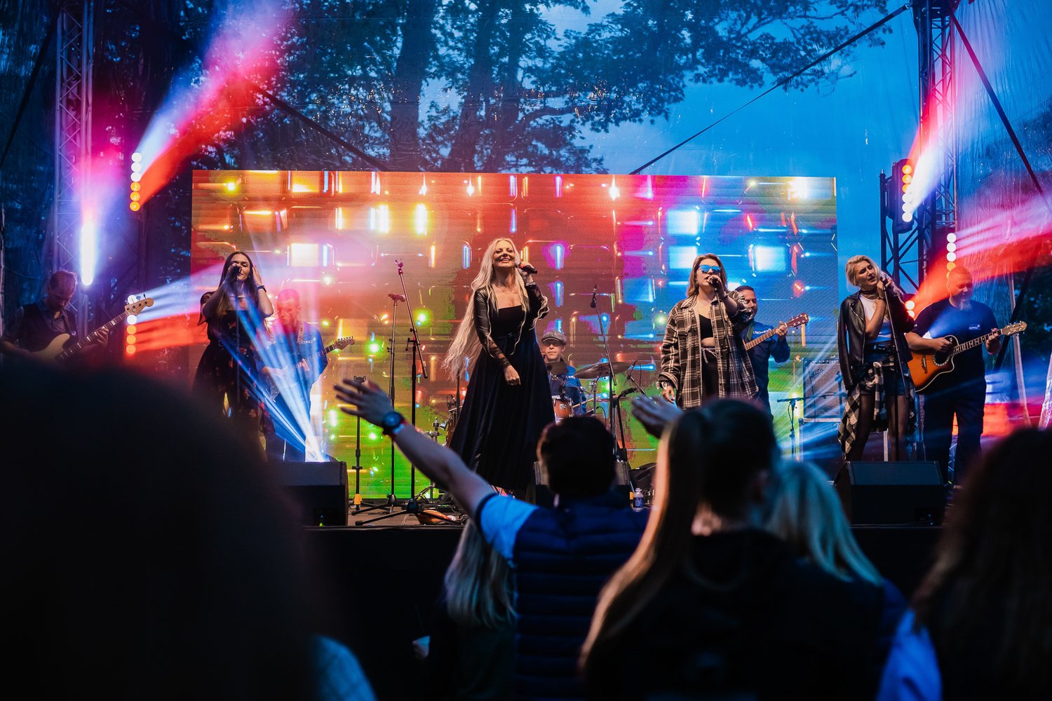 Live concert atmosphere with stage lighting and audience energy
