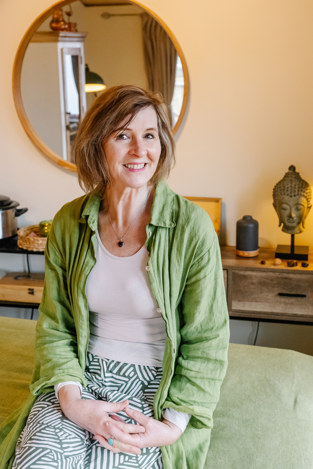 Seated portrait in a calm massage and wellbeing studio