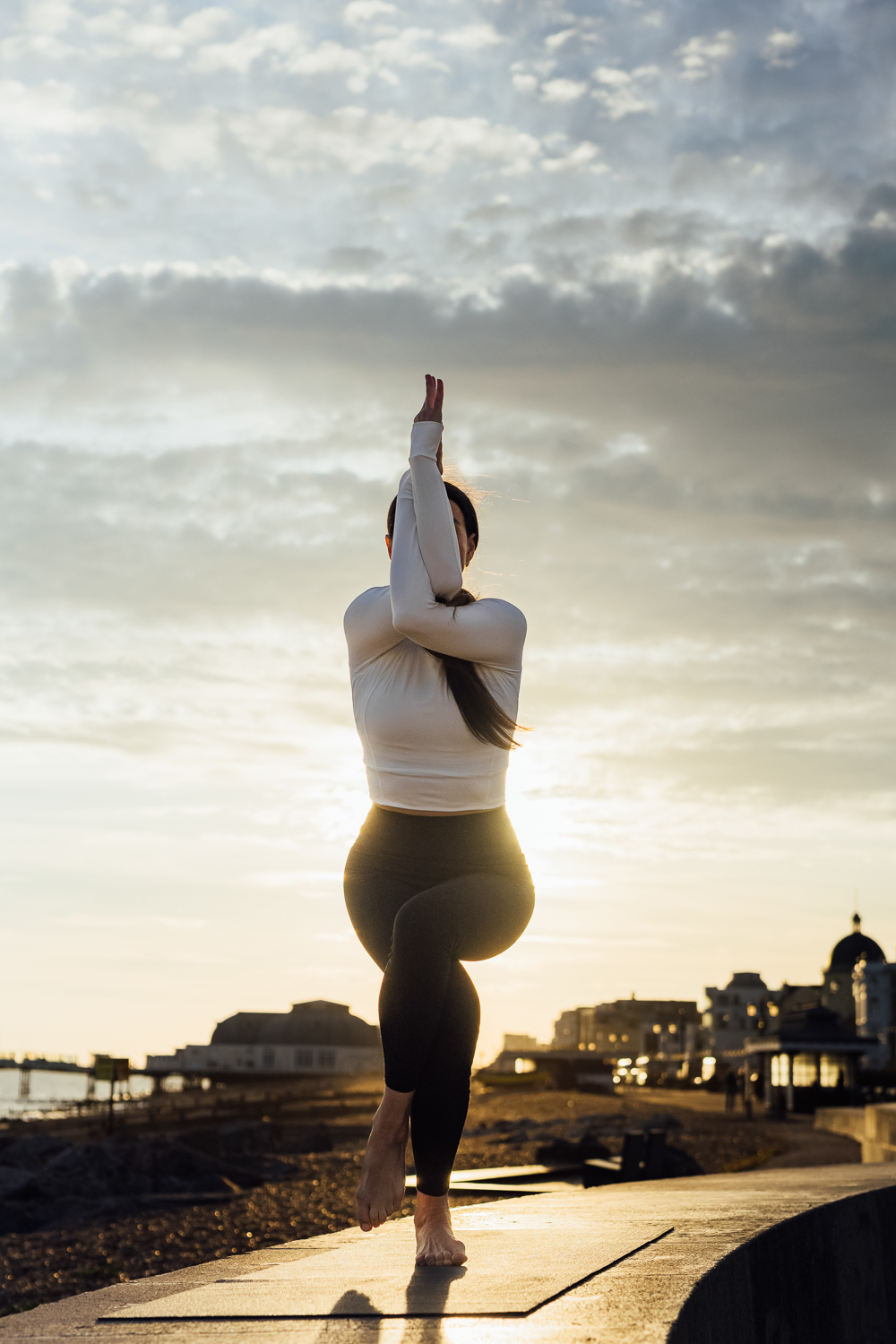 Silhouette yoga pose at golden hour by the sea