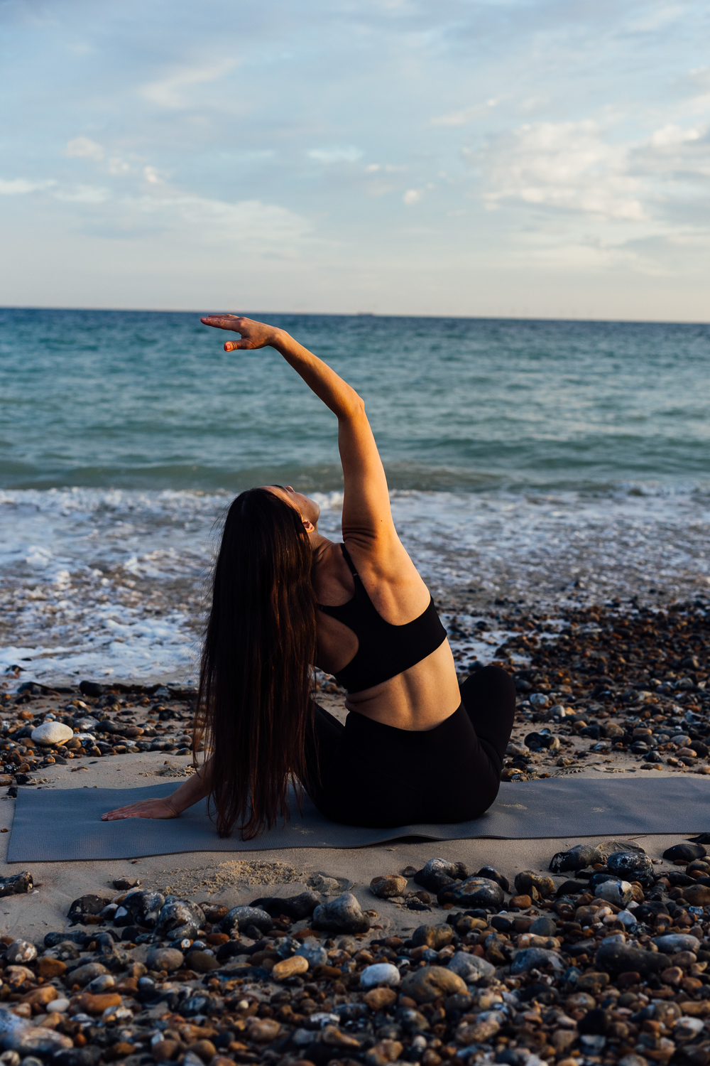 Beach yoga movement photographed on the shoreline